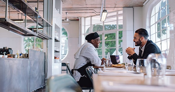 Men talking in restaurant